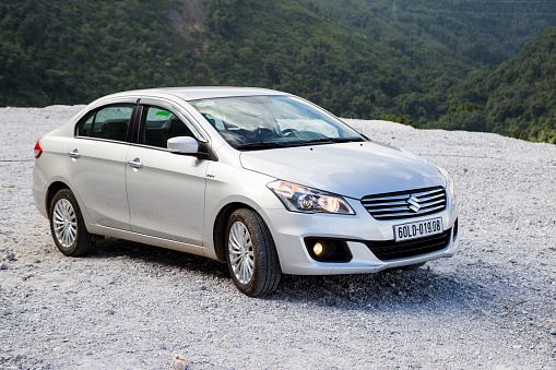 Hoabinh, Vietnam - Nov 16, 2016: Suzuki Ciaz sedan car is running on the mountain road in test drive in Vietnam.