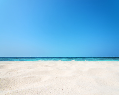 Sandy beach and blue sky background