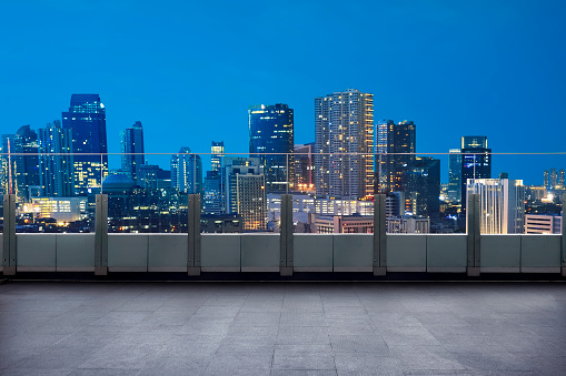 Empty terrace with cityscape and skyscraper at night