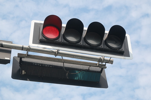  the traffic signal displays a red light (as the color for stop)