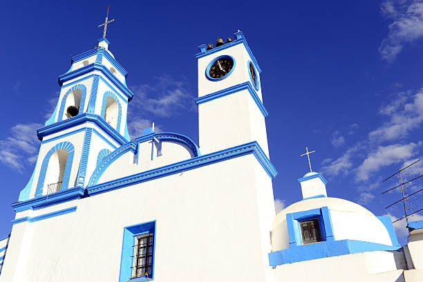 Colorful blue and white Church with blue sky background located near borders of Veracruz and Puebla, close to Pico de Orizaba, Iztaccihuatland Popocatepetl volcanoes, Mexico
