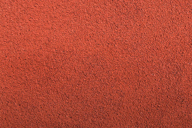 Running track rubber cover texture top view background. Running track rubber cover texture top view background. Closed up red crumb rubber outdoor running track surface. sports track stock pictures, royalty-free photos & images