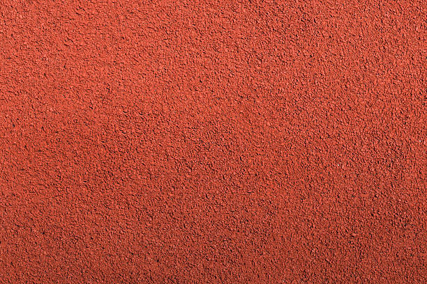 Running track rubber cover texture top view background. Running track rubber cover texture top view background. Closed up red crumb rubber outdoor running track surface. track stock pictures, royalty-free photos & images