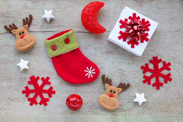Christmas socks and Christmas decoration on white wooden background,