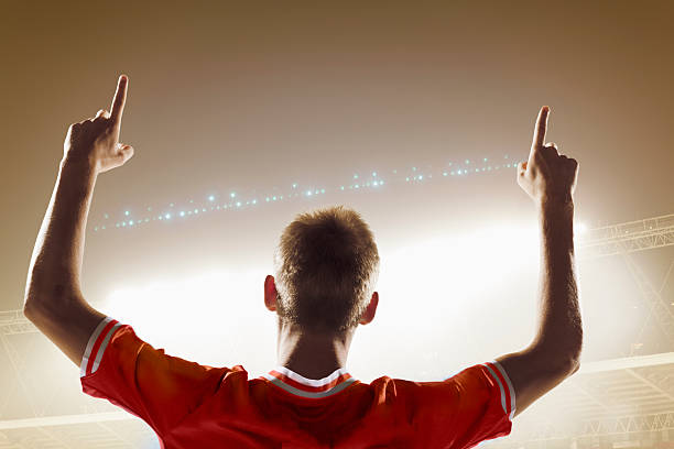 istock Athlete cheering in stadium with number one finger sign 637297466