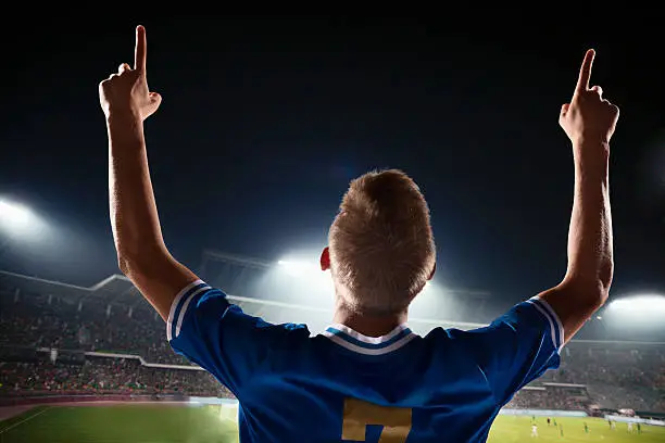 Photo of Athlete cheering in stadium with number one finger sign