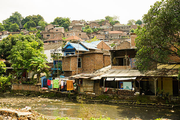 Slums near dirty river photo taken in Semarang Indonesia Slums near dirty river photo taken in Semarang Indonesia java jakarta slums stock pictures, royalty-free photos & images