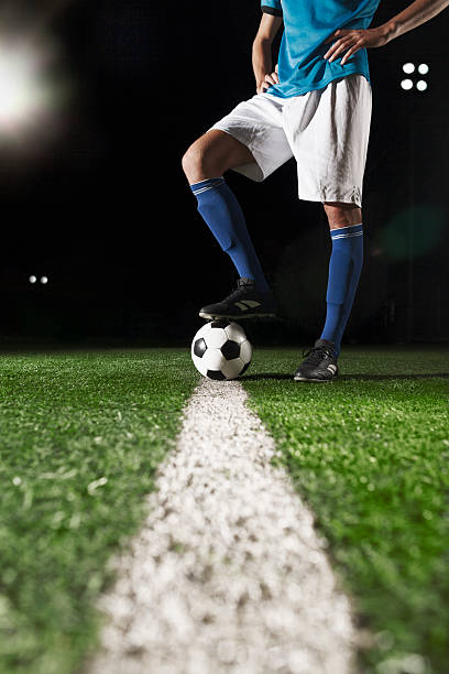 istock Foot on soccer ball mid field line 637298228
