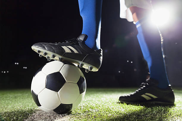 istock Foot on soccer ball mid field line 637298304