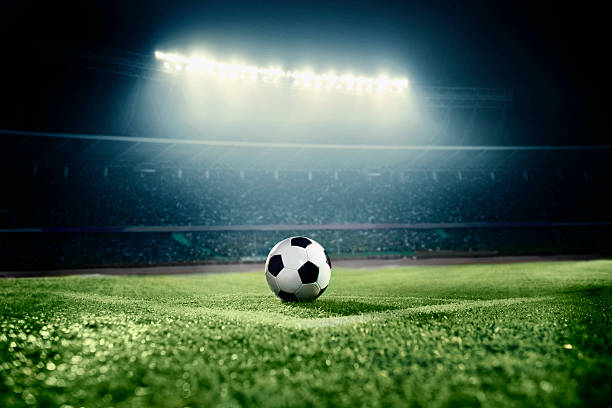 View of soccer ball on athletic field in stadium arena stock photo