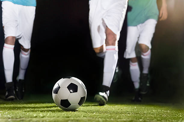 istock Athlete dribbling soccer ball on field 637298544