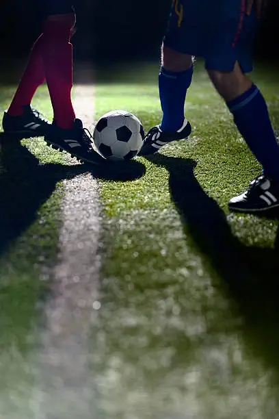Athlete dribbling soccer ball on field