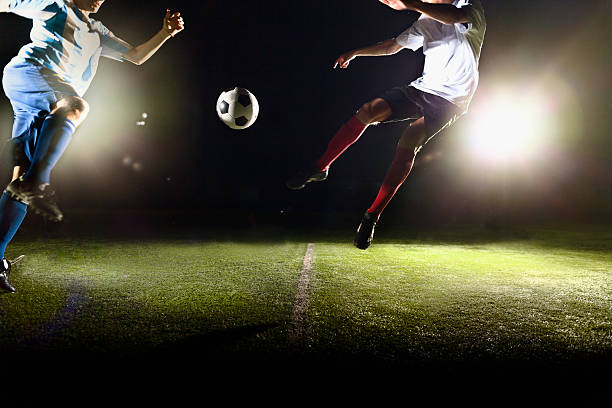 istock Athletes jumping towards soccer ball on field during game 637298712