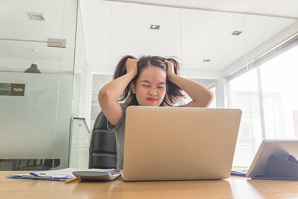 Asian businesswoman feel over stressed with her daily business stock photo