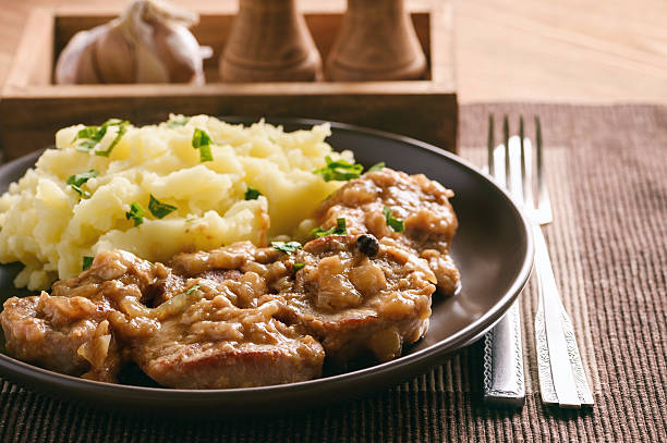 istock Pork tenderloin cooked in onion sauce served with mashed potatoes. 637301646