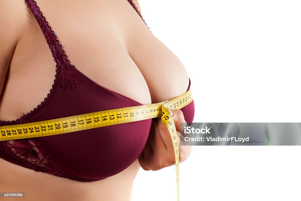 woman measured her breast with a measuring tape woman measured her huge breast with a measuring tape Breast Stock Photo