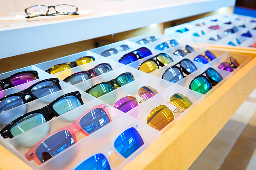 colorful sunglasses on wood shelf