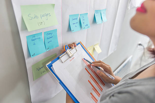 istock Close-up woman hands holding and pointing at sales chart document 637303240