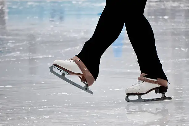 Still capture of recreational figure skater ice skates on outdoor rink