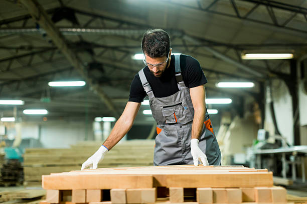 istock Young worker works in a factory for the production 637304430