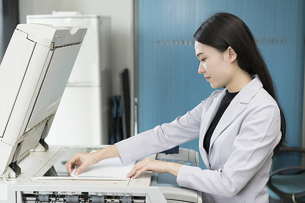 istock asian woman secretary using copy machine in the office 637307002