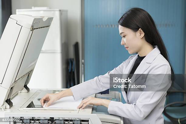 Asian Woman Secretary Using Copy Machine In The Office Stock Photo - Download Image Now