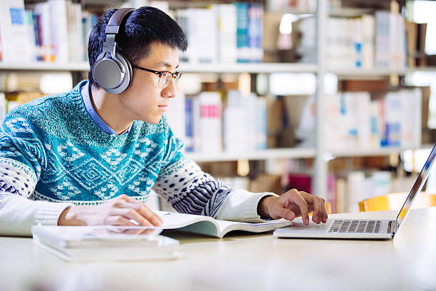 istock young asian man with headset in library 637309392