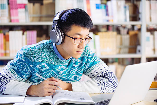 istock young asian man with headset in library 637309624