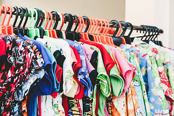 istock Colorful child clothes hang on rack in store 637310590