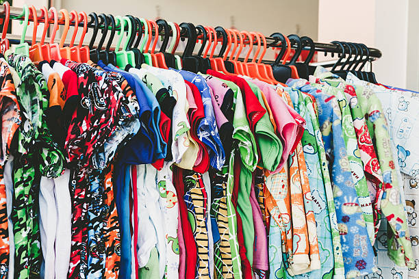 istock Colorful child clothes hang on rack in store 637310774