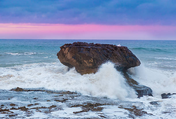 Close up of waves breaking on rocks