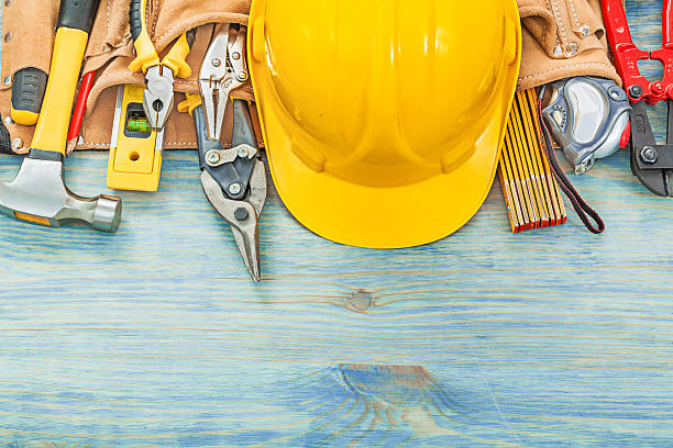 istock Leather toolbelt on wooden board construction concept 637311472