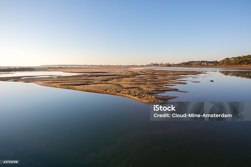 dusk on lagoon, Casse de la Belle Henriette, Vendee, France dusk on lagoon at nature reserve Casse de la Belle Henriette after sea went over the dike after the storm Xynthia in February 2010 Beach Stock Photo