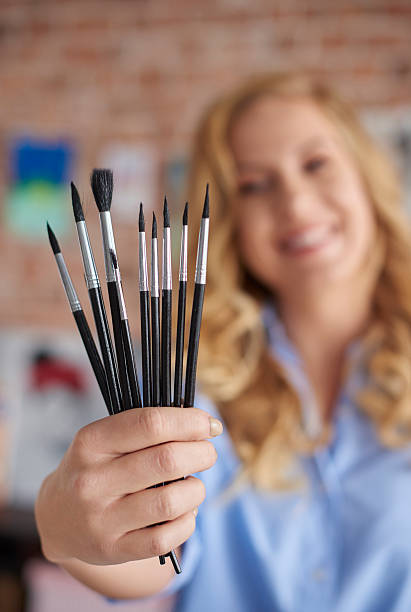 istock Female painter with set of paintbrushes 637314376