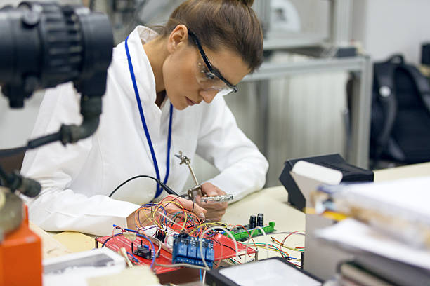 istock Female electrician working on circuit board at desk 637315766
