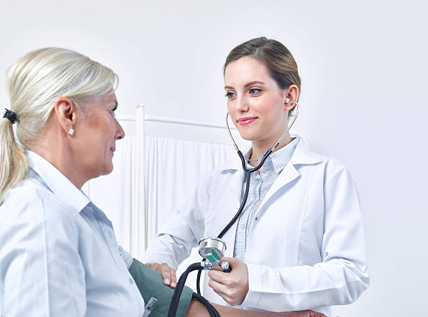 istock Doctor checking patients blood pressure 637316420