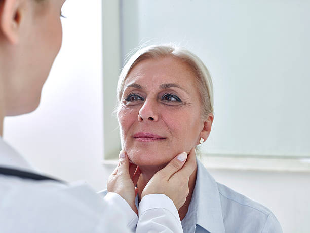 istock Doctor examining womans throat 637316926