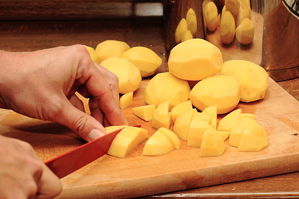istock Potato, knife, cutting board and your hands 637317050