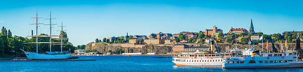 Stockholm harbour Gamla Stan Sodermalm waterfront cityscape panorama Sweden Panoramic view across the tranquil waters of the blue harbour, sailing ships and ferries overlooked by Sodermalm and Gamla Stan in the heart of Stockholm, Sweden's vibrant capital city. sodermalm photos stock pictures, royalty-free photos & images