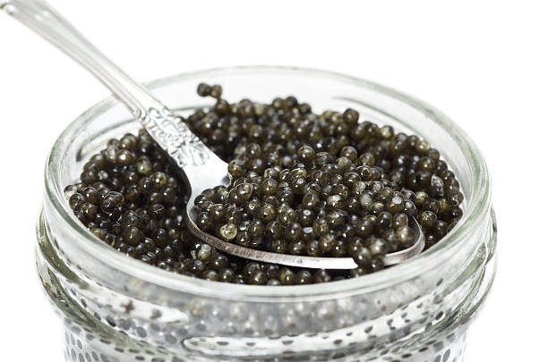istock Black caviar in a jar with a spoon closeup 637320986