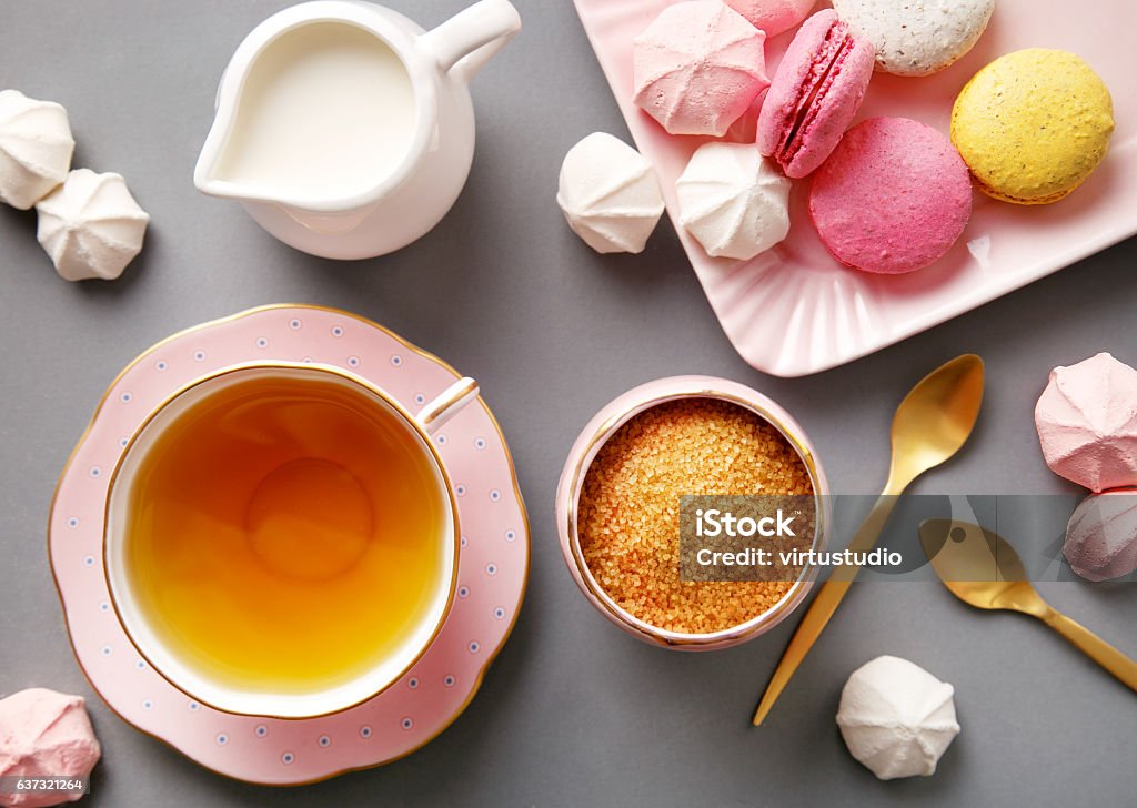 Tea in pink cup flat lay on gray background Tea in pink cup flat lay on gray background. Top view Afternoon Tea Stock Photo