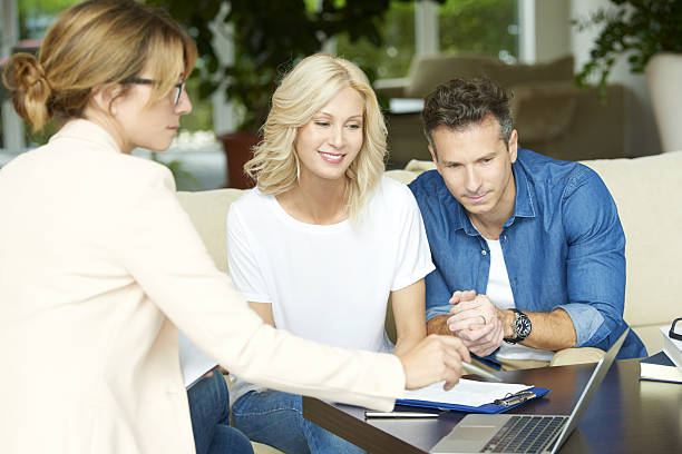 istock Happy couple with investment advisor 637321642