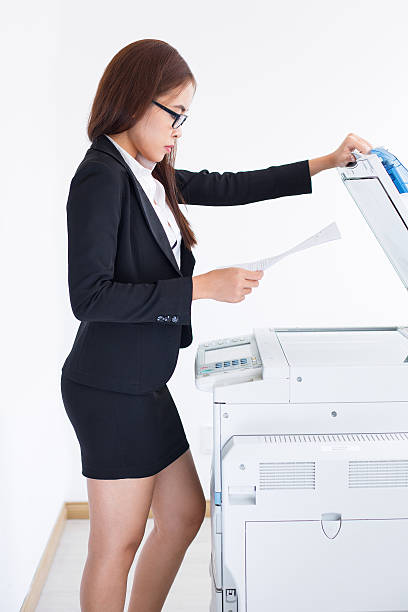 istock Asian Female Secretary Standing and Using Copier 637321724