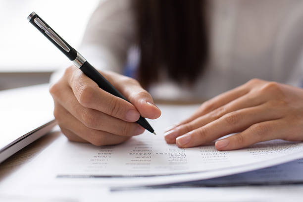 istock Cropped View of Employee Working with Document 637321910