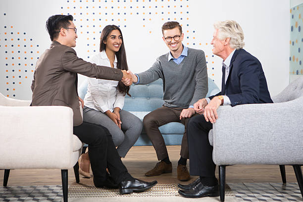 istock Happy Business Partners Shaking Hands at Meeting 637322022