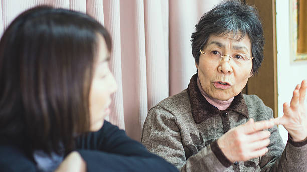 istock Old mother talking with daughter in a room 637324136
