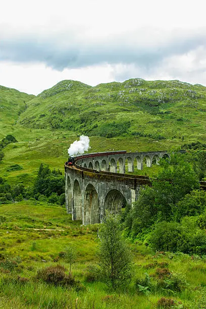 The Glenfinnan Viaduct railway viaduct on the West Highland Line in Glenfinnan Scotland. Located at the top of Loch Shiel the viaduct overlooks the Glenfinnan Monument and the Loch Shiel