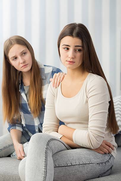 istock Sad girl comforted by her friend 637326372