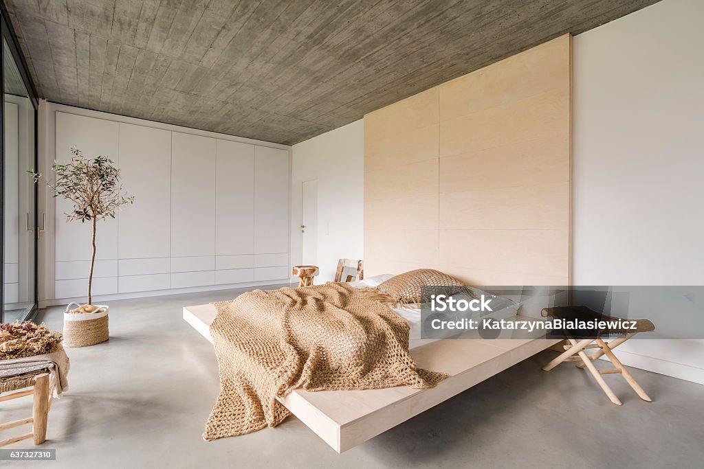 Bedroom with wooden ceiling Light bedroom with wooden ceiling and large bed Bedroom Stock Photo