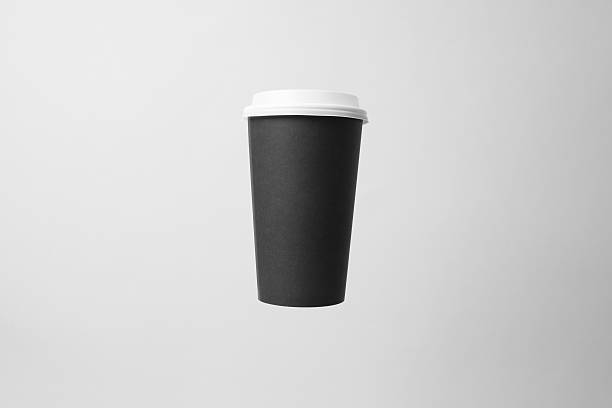 istock Blank black paper cup with white cap in the air 637327638